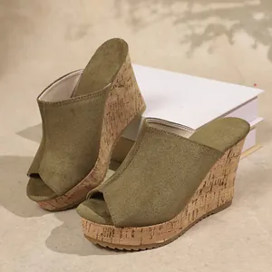 Close-up detail of olive green suede peep-toe wedge mule with textured cork platform sole