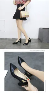 Detailed view of elegant black pointed-toe pumps with chunky heels worn by a fashion model