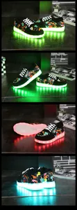 Detailed view of graffiti LED sneakers with vibrant glowing soles and USB charging