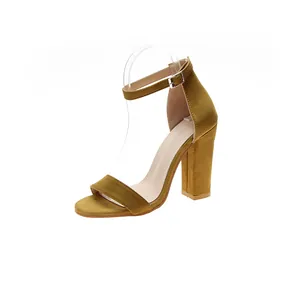Close-up view of a mustard yellow suede chunky heel sandal featuring an elegant ankle strap