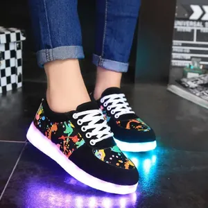 Detailed view of LED luminous sneakers with colorful graffiti pattern and glowing sole.