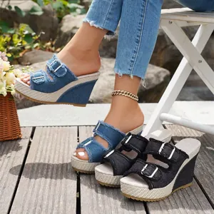 Denim wedge sandals with belt buckles and open toe design for stylish summer wear.