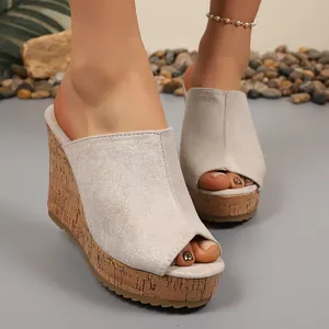 Close-up of gray suede peep-toe wedge slides with cork platform sole