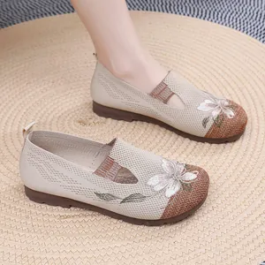 Detailed view of floral embroidery on breathable knit loafers with soft soles