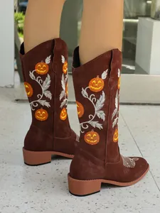 Detailed shot of brown Western boots with festive orange pumpkin embroidery
