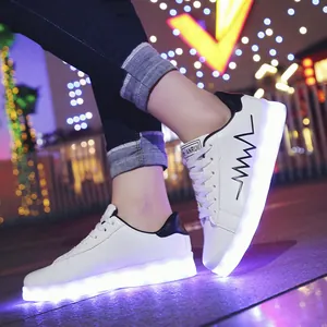 Trendy white LED light-up sneakers with USB charging for men and women night wear.