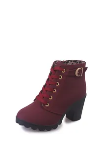 Detail shot of wine red chunky heel ankle boots featuring leopard print lining and gold eyelets