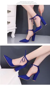 Detailed view of royal blue suede pointed toe pumps with chunky heels and ankle ties