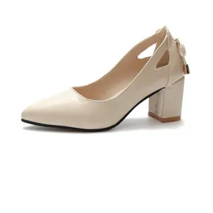 Side profile of elegant beige pointed-toe chunky heel pumps with heel bow detail.