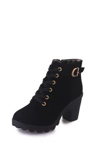 Detailed view of black lace-up ankle boots with thick high heels and gold buckle.