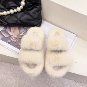 Close-up of off-white fluffy faux fur double strap slippers on a neutral background.
