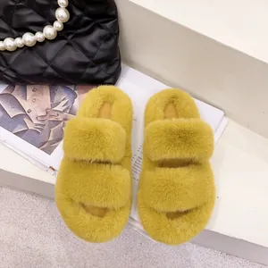 Top view of cozy yellow faux fur slippers with double straps on a white background