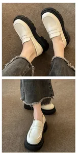Close-up detail of stylish white thick-soled loafers with retro JK style worn on feet