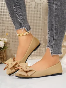 Detailed view of khaki square toe flats with a large layered bowknot decoration