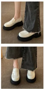 Detail view of white platform loafers with thick black soles and JK retro style