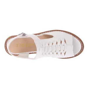 Top-down view of white woven Roman sandals featuring a buckled ankle strap for women.