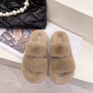 Close-up detail of fluffy double-strap beige slides for cozy indoor winter wear.