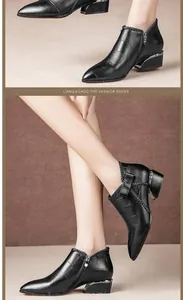 Detailed view of women's black pointed toe Chelsea boots featuring a stylish bow and side zipper