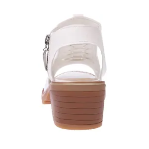 Back view of white hollow Roman sandals with a chunky brown medium heel for women