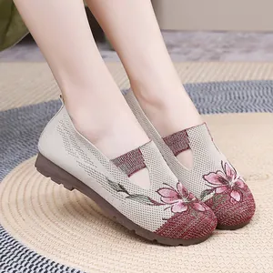Close-up of comfortable women's mesh loafers with pink floral embroidery and soft soles