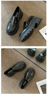 Close-up detail of black platform loafers with thick soles and retro design