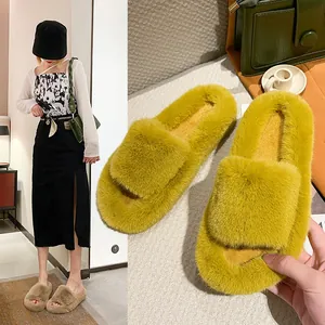 Detail of plush fuzzy slippers with thick soles and open-toe design for winter.