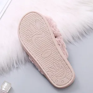 Detail view of pink fuzzy slipper sole with non-slip texture and size marking