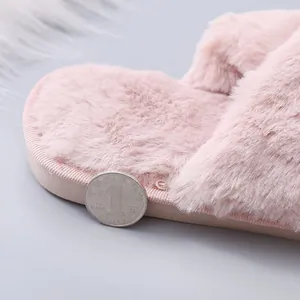 Detail view of pink fluffy winter slipper showing thick sole and soft plush material