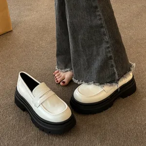 Stylish white platform loafers with thick soles in a French retro vintage style