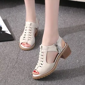 Close-up detail of stylish beige hollow-out Roman sandals featuring comfortable block heels