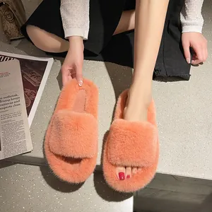 Close-up of soft orange fuzzy open-toe slippers with a thick platform sole for women.