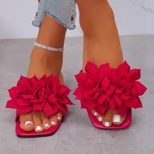 Detailed view of fuchsia flat slippers with large 3D floral decoration and square toe