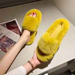 Soft yellow faux fur slippers with thick sole and open-toe cross strap design.