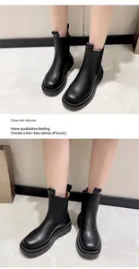 Close-up detail of women's black platform Chelsea boots with thick soles on model