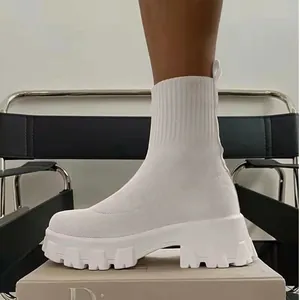 Detailed view of white knitted fly-weave sock boots featuring a chunky lug sole.
