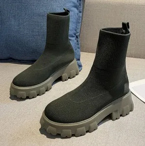 Detail view of women's olive green flyknit sock boots with thick lug soles