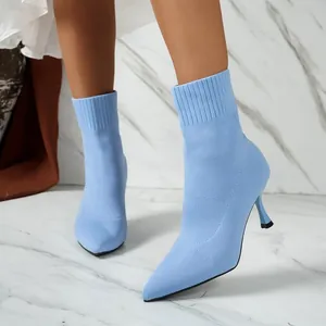Detailed side view of light blue knitted pointed toe stiletto sock boots for women.