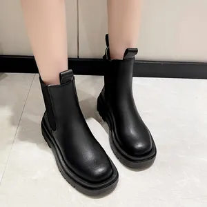 Close-up of black British-style Chelsea boots with chunky platform soles for women