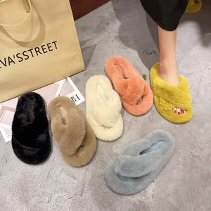 Detail view of colorful plush cross-strap slippers with soft faux fur texture.