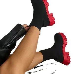 Stylish women's black knit sock boots featuring a bold chunky red lug sole for autumn