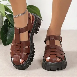 Close-up view of brown platform gladiator sandals with hollow-out design and thick soles