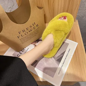 Close-up of vibrant yellow thick-sole furry slippers with cross-strap open-toe design