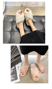 Detail view of soft pink and white cross strap fuzzy slippers worn indoors on feet