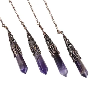 Close-up of natural amethyst crystal pendulums with antique bronze hexagonal point design.