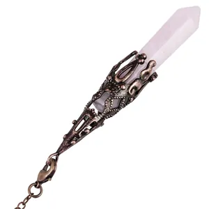 Close-up of a rose quartz crystal pendulum with bronze decorative metal cap and chain