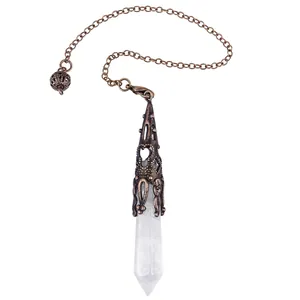 Detailed macro view of hexagonal clear crystal pendulum with ornate copper metal cap