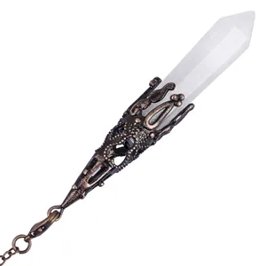 Detailed view of hexagonal white crystal pendulum with bronze filigree cap and chain