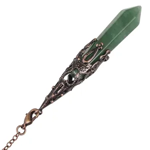 Detailed view of green crystal hexagonal pillar pendant with ornate antique copper sleeve