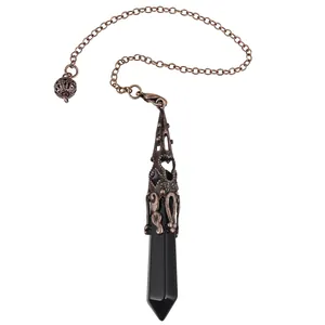Detailed view of a hexagonal black stone pendulum featuring an ornate bronze filigree metal cap