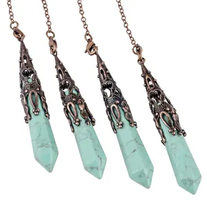 Detailed view of turquoise hexagonal stone pendants with ornate bronze filigree caps
